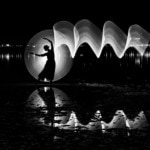 Silhouette of a woman dancing outdoors on a lake with light painting and reflections on the water